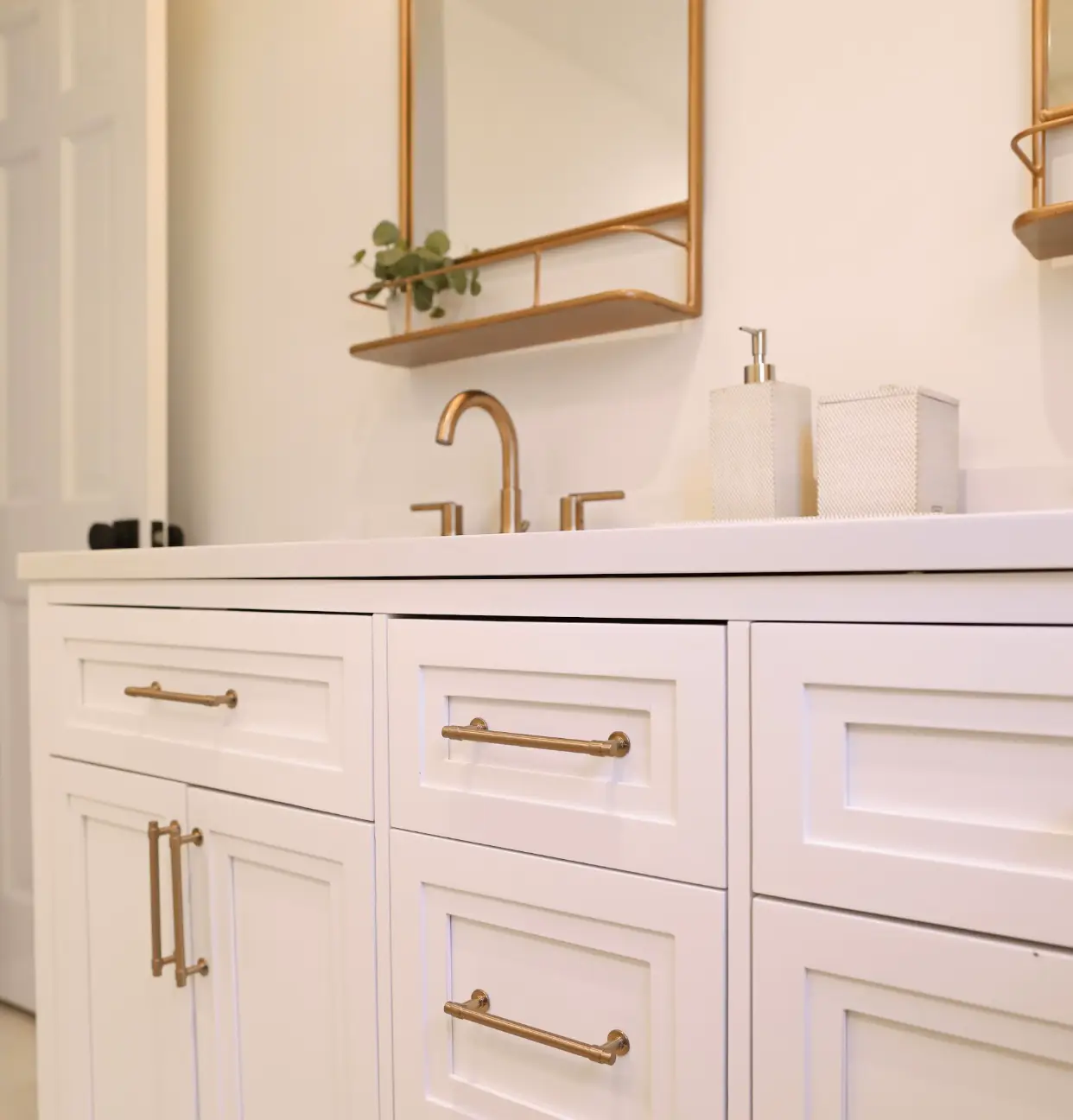 white bathroom counter with gold metal frames