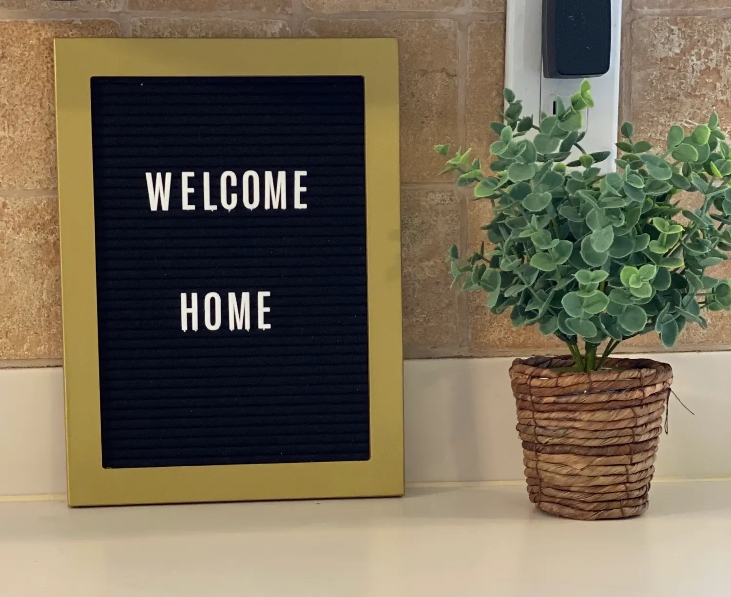 welcome home signage and plant